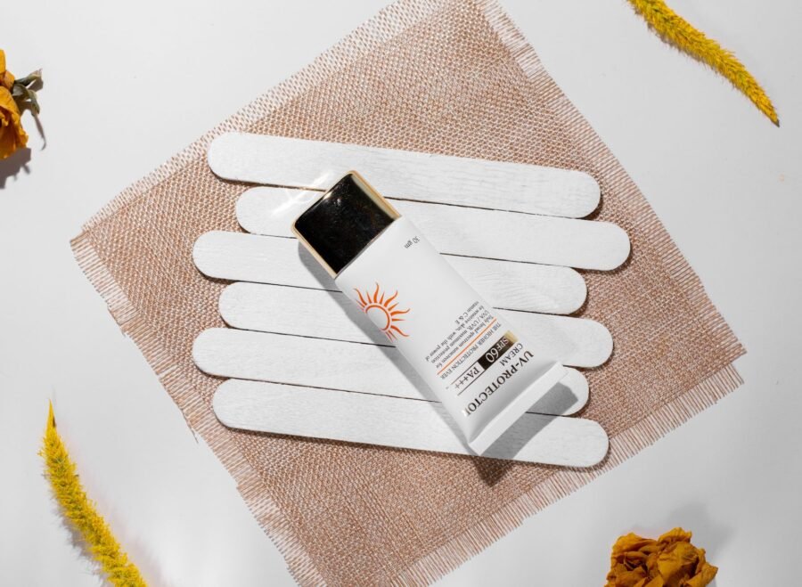 best sunscreen for summer in Pakistan – Minimalist flat lay of sunscreen SPF 60 with natural elements, enhancing beauty care theme.