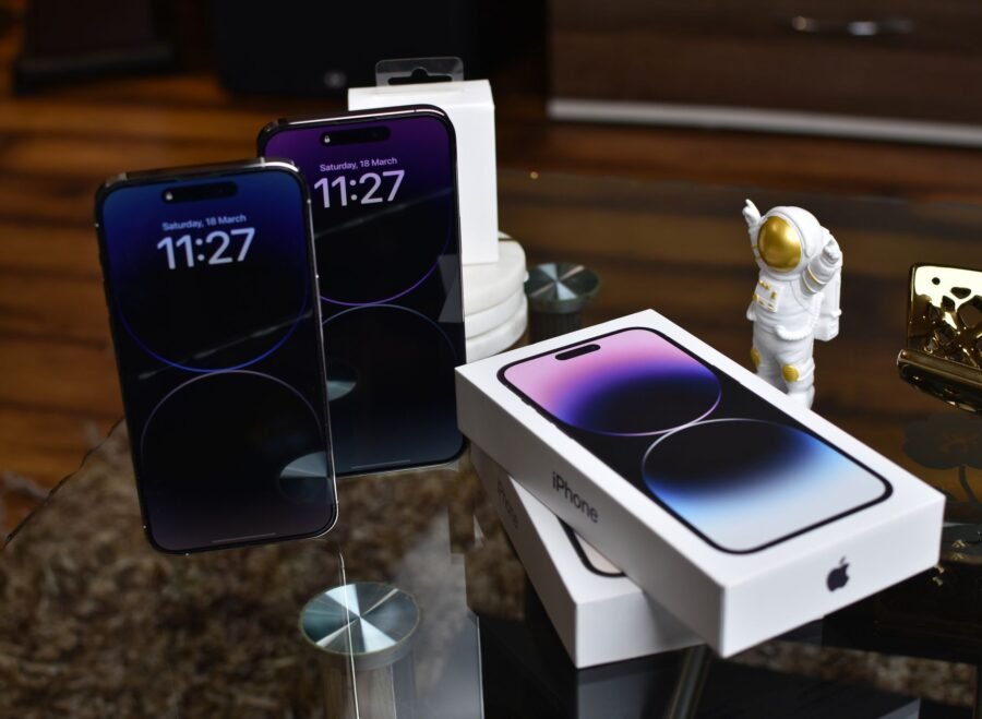 buy iPhone 18 Pro Max from Amazon in Pakistan – Close-up of Apple iPhone 14 Pro Max with astronaut figurine on a reflective surface.