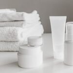 CeraVe price in Pakistan – Minimalist arrangement of white skincare products and towels for a modern aesthetic.