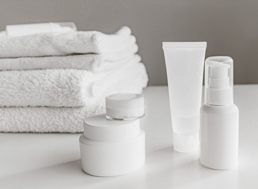 CeraVe price in Pakistan – Minimalist arrangement of white skincare products and towels for a modern aesthetic.