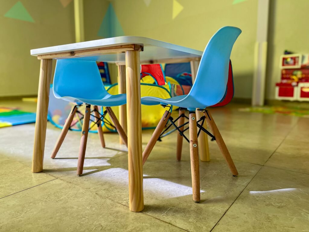 baby study table chair set price in pakistan – Colorful and inviting kiddie area with modern chairs and a sturdy table in a vibrant playroom.