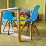 baby study table chair set price in pakistan – Colorful and inviting kiddie area with modern chairs and a sturdy table in a vibrant playroom.