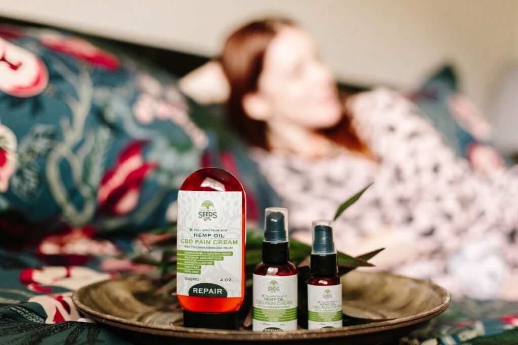 dooz 14000 spray price in pakistan – CBD hemp oil pain relief products displayed indoors with a relaxed person in the background.