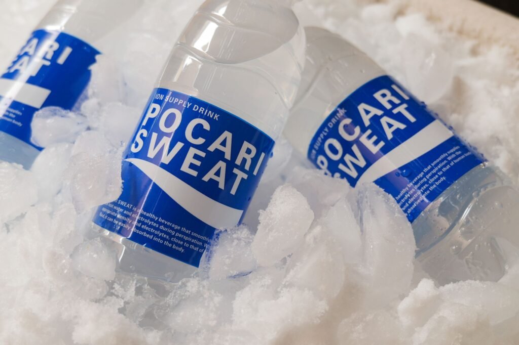 electrolyte supplements for summer Pakistan – Chilled Pocari Sweat bottles resting in ice, showcasing hydration and refreshment.