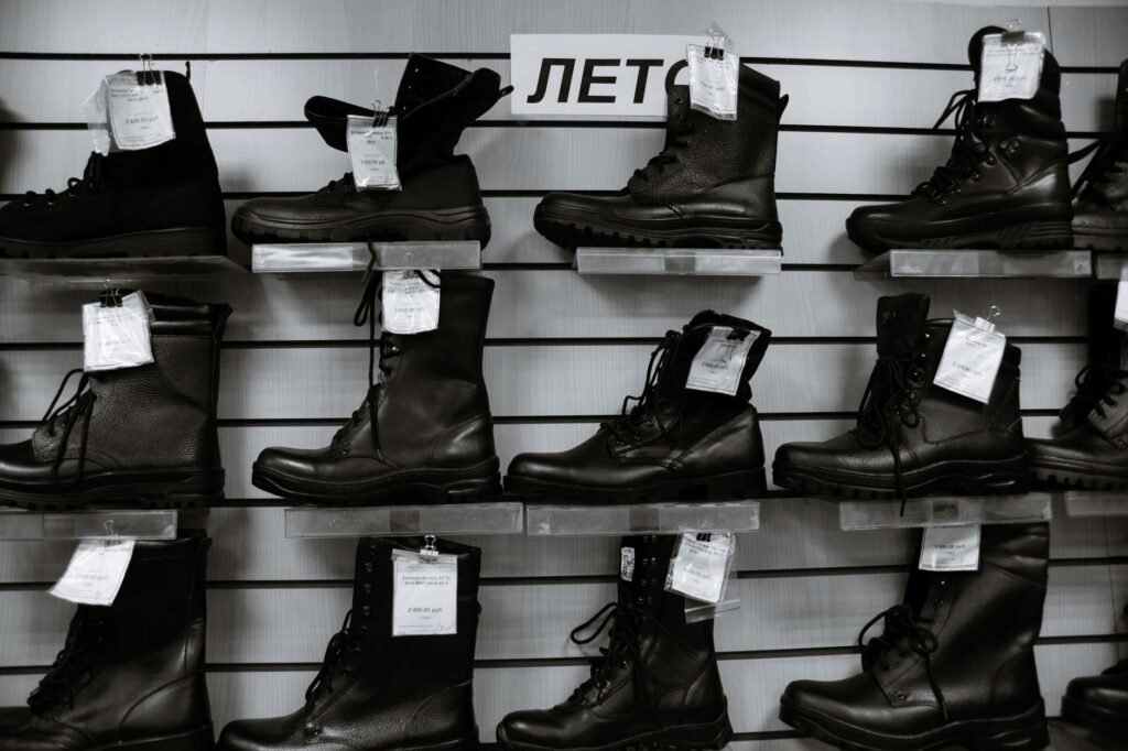 pak army shoes – Black and white high leather boots with laces placed on shelves in shop