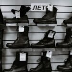 pak army shoes – Black and white high leather boots with laces placed on shelves in shop