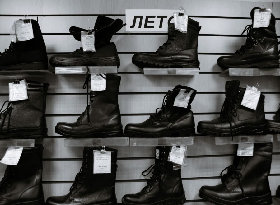 pak army shoes – Black and white high leather boots with laces placed on shelves in shop
