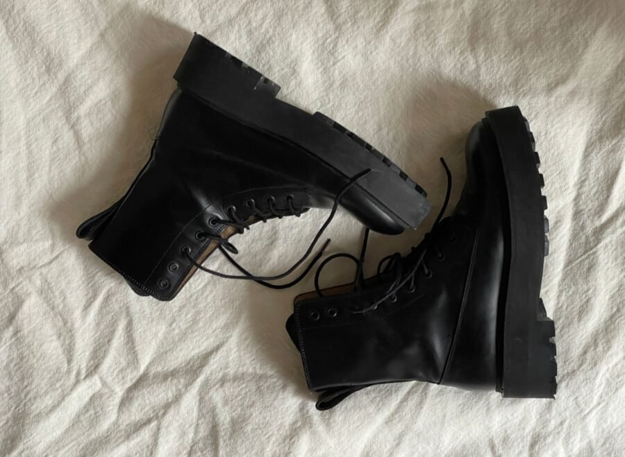 pak army shoes vs us tactical boots – Pair of black combat boots stylishly arranged on white fabric background.