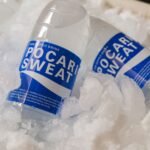 US electrolyte drinks for cricket fans Pakistan – Refreshing Pocari Sweat bottles embedded in ice, showcasing hydration and cooling.