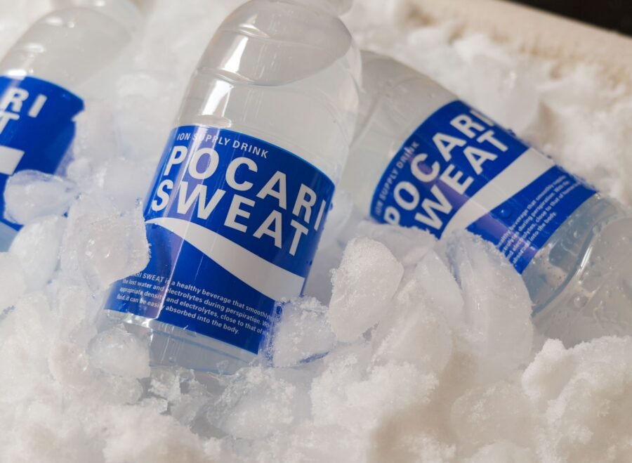 US electrolyte drinks for cricket fans Pakistan – Refreshing Pocari Sweat bottles embedded in ice, showcasing hydration and cooling.