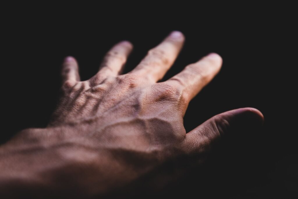 vein detector price in pakistan – Detailed image of a human hand showing prominent veins against a dark background.