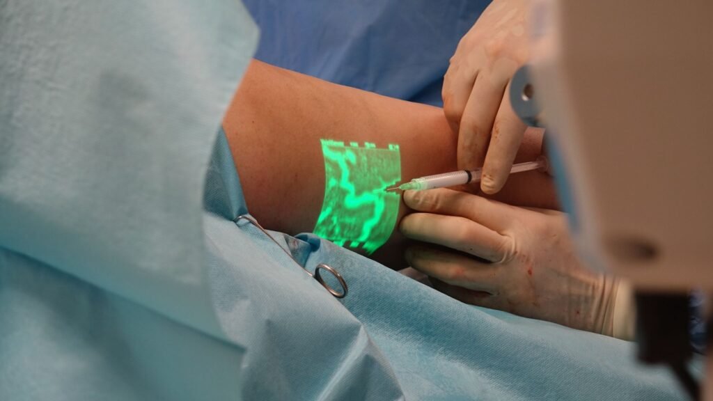 vein detector price in pakistan – A doctor performs a medical procedure using advanced vein visualization technology.