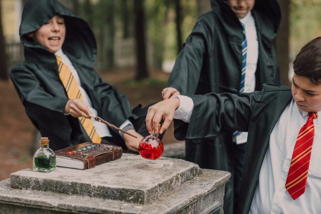 harry potter costume pakistan – Three children in wizard costumes play with potions and wands in a fantasy-themed setting outdoors.