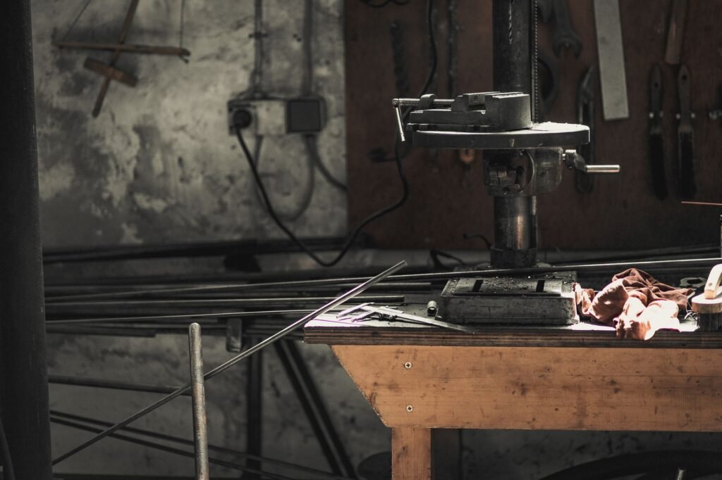 makita drill machine price in pakistan – A detailed view of a metalwork workshop showcasing tools, machinery, and steel bars.