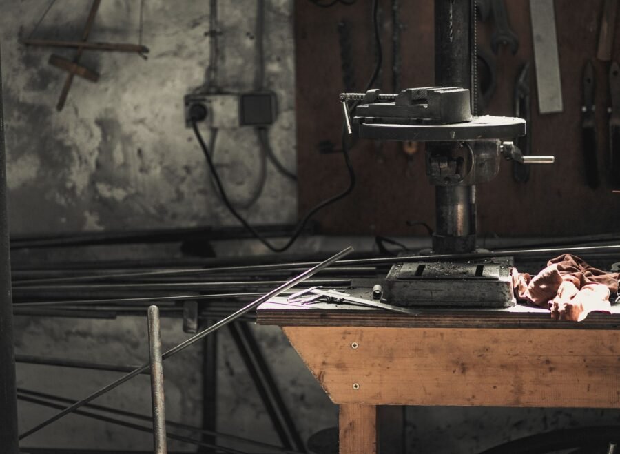 makita drill machine price in pakistan – A detailed view of a metalwork workshop showcasing tools, machinery, and steel bars.