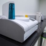 spectrophotometer price in pakistan – Sleek, modern laboratory equipment on a black countertop in a professional lab setting.