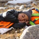 sleeping bag pakistan – A child peacefully sleeping outdoors during a hiking adventure in Pakistan.