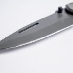 tactical knives pakistan – Sharp stainless steel folding knife blade close-up with a sleek design. Perfect for tactical and survival purposes.