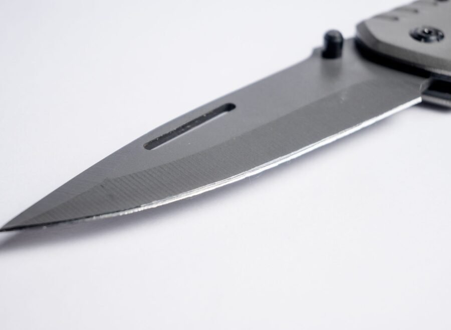 tactical knives pakistan – Sharp stainless steel folding knife blade close-up with a sleek design. Perfect for tactical and survival purposes.